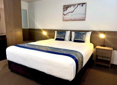 King Room With A Spacious King-Size Bed And Bedside Table At The Motor Inn — Chalet Motor Inn In Bundaberg West, QLD King Room With A Spacious King-Size Bed And Bedside Table At The Motor Inn — Chalet Motor Inn In Bundaberg West, QLD