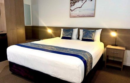 King Room With A Spacious King-Size Bed And Bedside Table At The Motor Inn — Chalet Motor Inn In Bundaberg West, QLD King Room With A Spacious King-Size Bed And Bedside Table At The Motor Inn — Chalet Motor Inn In Bundaberg West, QLD