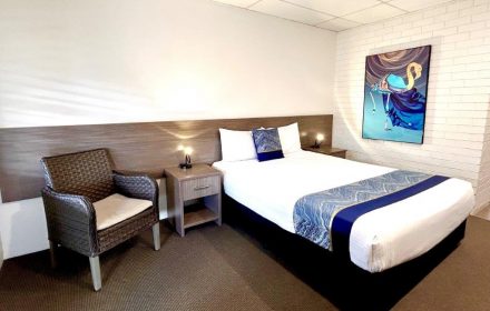 Queen Room With TV On And Visible Bathroom Entrance — Chalet Motor Inn In Bundaberg West, QLD Queen Room With TV On And Visible Bathroom Entrance — Chalet Motor Inn In Bundaberg West, QLD